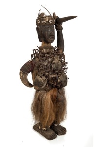 A fetish figure, carved wood with nails, shells, horn hair, feathers and fibre, West African origin, ​​​​​​​77cm high