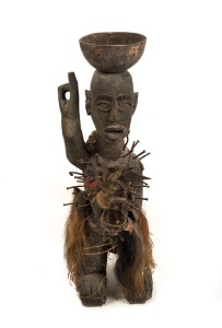 A fetish figure, carved wood with nails, horn hair, feathers and fibre, West African origin, 75cm high