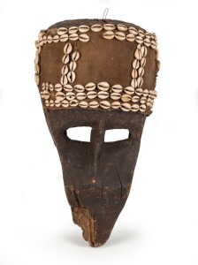 A zoomorphic tribal mask, carved wood, shell and fibre, East African origin, 50cm high