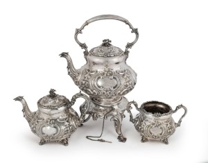 A stunning three piece antique silver plated spirit kettle on stand with matching teapot and sugar basin, decorated in the Rococo style, 19th century, the kettle 44cm high