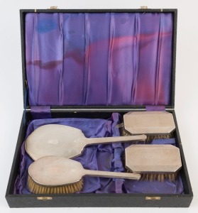 Four pieces of sterling silver vanity ware in plush box, early 20th century, ​​​​​​​the box 36.5cm wide