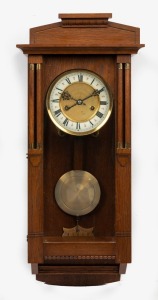 An antique timber cased wall clock with 8 day time and strike movement, enamel dial and Roman numerals, early 20th century, ​​​​​​​60cm high