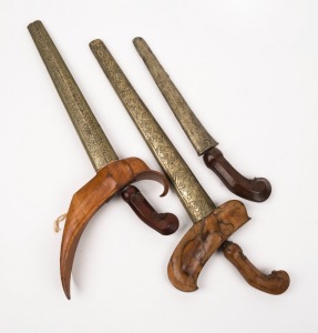 Three Indonesian Kris blades with scabbards, early to mid 20th century, the largest 43cm long overall