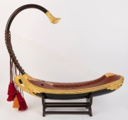 SAUNG Burmese harp of boat form, on stand, 20th century, 79cm high overall, 83cm long - 2