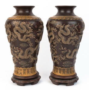 A pair of Chinese ceramic pâte-sur-pâte pottery vases on stands with dragon decoration, 20th century, impressed seal marks to bases, 41cm high