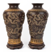 A pair of Chinese ceramic p&acirc;te-sur-p&acirc;te pottery vases on stands with dragon decoration, 20th century, impressed seal marks to bases, 41cm high