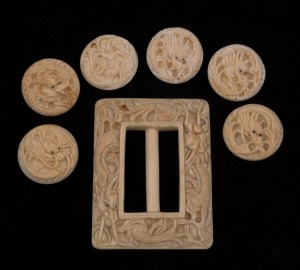 A Chinese carved ivory belt buckle, together with a set of six carved ivory buttons, early 20th century, (7 items), ​​​​​​​the buckle 7cm high