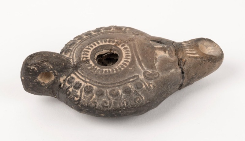 A Roman pottery oil lamp, 2nd century A.D. ​​​​​​​10.5cm long