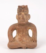 A Columbian pottery statue of a seated figure, 14.5cm high