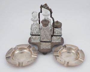 A pair of sterling silver ashtrays (196 grams total), together with a silver plated four bottle cruet set, 19th and 20th century, (3 items), the cruet set 20cm high