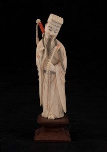 A Chinese carved ivory statue of a warrior, on wooden stand, early to mid 20th century, 15cm high overall