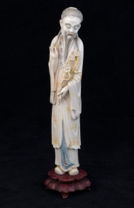 A Chinese carved ivory statue of an old man, on wooden stand, early to mid 20th century, 28cm high overall