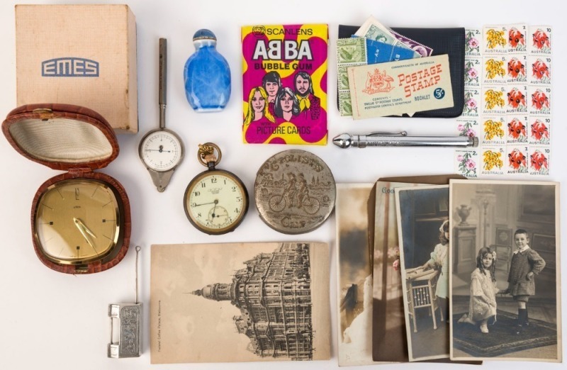 Assorted antique postcards, stamps, calling cards, pocket watch, travel clock, opium bottle, "Cycle Cup", Chinese furniture lock, ABBA Scanlens cards, pressure gauge and map measuring instrument, (15 items),