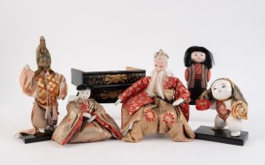 Five assorted vintage Japanese dolls on black lacquered stands, 20th century, the largest 18cm high