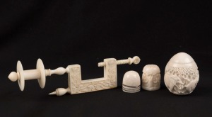 SEWING: Antique carved ivory cotton reel work clamp, together with two ivory thimbles and an Indian egg-shaped carved ivory thimble holder, 19th and 20th century, (4 items), ​​​​​​​the clamp 12cm high