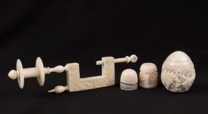 SEWING: Antique carved ivory cotton reel work clamp, together with two ivory thimbles and an Indian egg-shaped carved ivory thimble holder, 19th and 20th century, (4 items), the clamp 12cm high