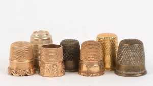 SEWING: Group of seven antique and vintage thimbles including gold, silver, gold plated and white metal, 19th and 20th century, 10 grams gold weight