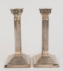 A pair of Corinthian column silver plated candlesticks, 19th century, 25cm high