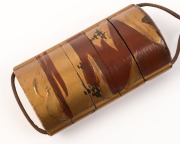 An antique Japanese inro, lacquered cherry wood with gilded landscape scene, with ceramic ojime&nbsp;and Foo dog carved boxwood netsuke, Meiji period, ​​​​​​​the inro 9cm high - 3