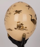 An antique Japanese gold lacquered decorated ostrich egg ornament on original lacquered stand shaped as a bird claw, Meiji period, 19th century, 26cm high. PROVENANCE: Purchased at Christie's Auctions South Kensington, London in the late 1980s for $2000. - 2