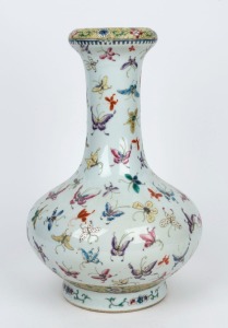 A Chinese bottle shaped porcelain vase decorated with butterflies and floral motif, late Republic period, 20th century, six character iron red Qinglong mark, ​​​​​​​36cm high