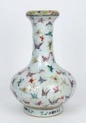A Chinese bottle shaped porcelain vase decorated with butterflies and floral motif, late Republic period, 20th century, six character iron red&nbsp;Qinglong&nbsp;mark, ​​​​​​​36cm high
