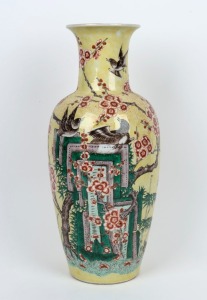 A Chinese famille vert porcelain vase with yellow ground adorned with magpies and blossoms, 20th century, leaf mark to base, 45cm high