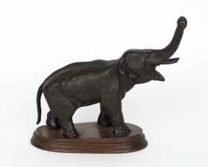 Mystery clock base, bronzed cast metal elephant with raised trunk, on wooden plinth, 19th/20th century, 22cm high, 22cm long