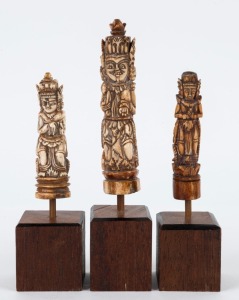 Three Burmese carved bone knife handles, mounted on later wooden stands, 19th and 20th century, the largest 13cm high, 19.5cm high overall