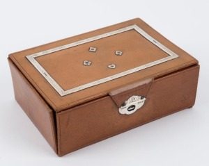 An English leather covered travelling games box with sterling silver mounts and clasp, with fitted interior for the games of 'Bridge', 'Bezique' and 'Rubicon Bezique'. Hallmarked for London 1929. 6cm high, 16cm wide, 11cm deep