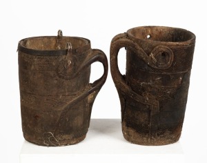 Two antique Tibetan carved wooden butter churn mugs, 20th century, The largest 26cm high, 19cm wide  