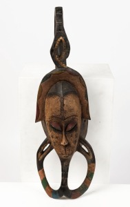 A ceremonial mask, carved wood with painted finish, Guro tribe, Ivory Coast, West Africa, 74cm high 