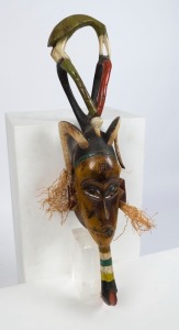 A ceremonial mask, carved wood with painted finish with fibre, Guro tribe, Ivory Coast, West Africa,73cm high 