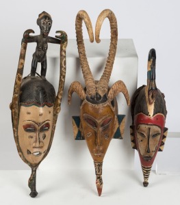 Three African mask, carved wood with painted finishes, Guro tribe, Ivory Coast, West Africa, ​​​​​​​The largest 65cm high