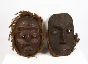 Two tribal masks, carved wood with fibre and remains of ochre decoration, African origin, The larger 47cm high