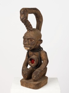 A fetish sculpture, carved wood with beads, shells and textile, West African origin, 59cm high