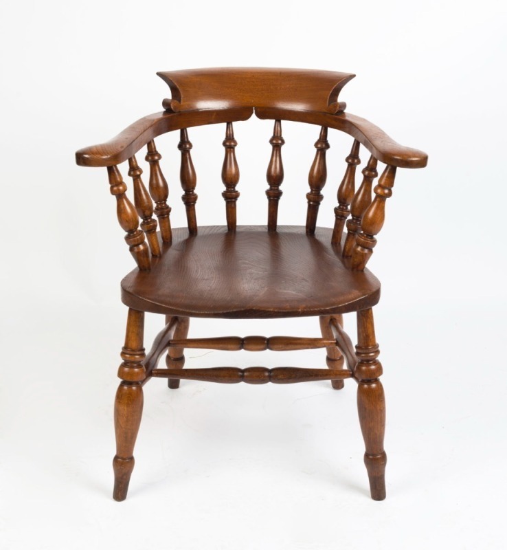 A Windsor style armchair with elm saddle seat, beech baluster turned back support and cross stretcher base, circa 1910 79cm high, 68cm across the arms.