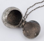 An antique Malaysian silver betelnut&nbsp;(sirih) set with ornate incised floral decoration. Consisting of a betel box and lime container joined with a chain. Late 19th early 20th century. Private collection, Melbourne. Acquired in The Hague, Holland in 1960. - 2