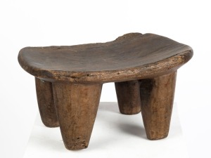 A tribal milking stool of carved wood, Senufo tribe, African origin, 39cm high