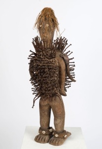 A tribal fetish sculpture of carved wood, shell, nails and fibre, Congo origin, 74cm high