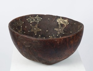 An African servery bowl, carved wood with metal alloy decoration, North African origin, ​​​​​​​17cm high, 38cm diameter