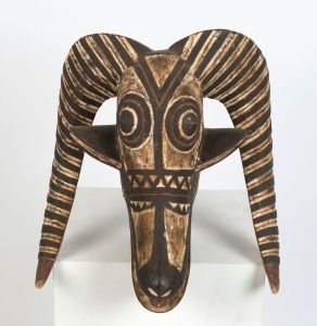 A ram's head tribal headdress, carved wood with polychrome finish, Burkina Faso, West African,  45cm high 