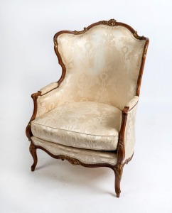 A fine Italian wingback armchair, carved mahogany with gilt decorated highlights, 20th century 11cm high, 75cm across the arms