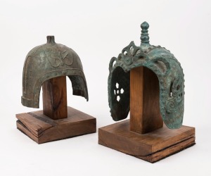 Two archaic style Chinese bronze military helmets, 20th century, 27cm and 21cm high