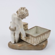 AMPHORA Austrian porcelain figural bowl in the form of a child holding two baskets, late 19th century, stamped "Imperial Amphora, Turn, Austria" with crown mark, ​​​​​​​22cm high - 2