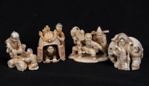Four Kyoto school Japanese carved ivory netsuke including an elephant figural group, wood cutters, samurai helmet group and a figural group with fan, 20th century, ​​​​​​​the largest 4cm high