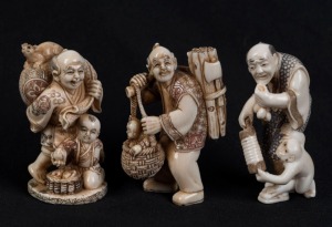 Three Kyoto school Japanese carved ivory netsuke of standing figures including wood cutter, man with monkey and figural group with rat, 20th century, ​​​​​​​the largest 5cm high