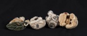 Four Japanese carved ivory netsuke of seated figures including a bird man, kneeling man, seated man with stick and a wandering man , 20th century, ​​​​​​​the largest 3.5cm high - 3