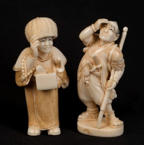 Two Japanese carved ivory netsuke of standing figures with swords, 20th century, ​​​​​​​the larger 5.5cm high