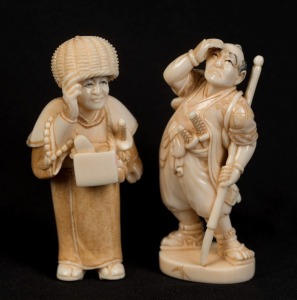 Two Japanese carved ivory netsuke of standing figures with swords, 20th century, the larger 5.5cm high
